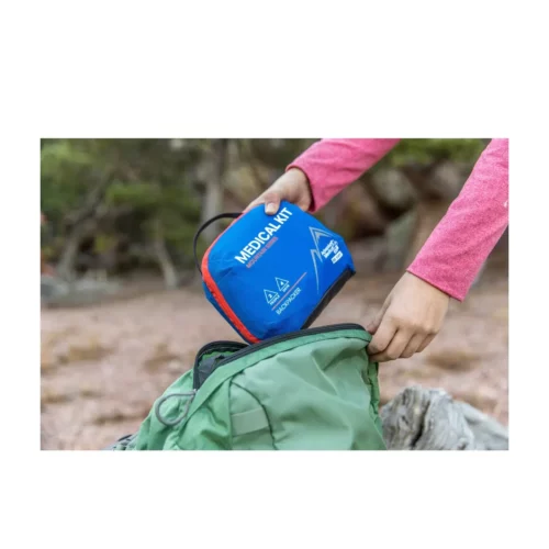 Backpacker Adventure Medical Kit being placed in backpack