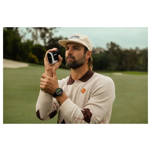 Male golfer using Garmin Approach Z30 laser rangefinder to take measurements on the green