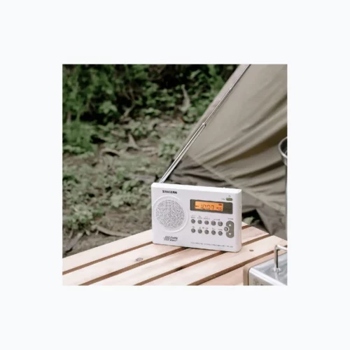 Sangean PR-D9W Portable AM / FM Stereo Radio in white with antenna out on bench by tent