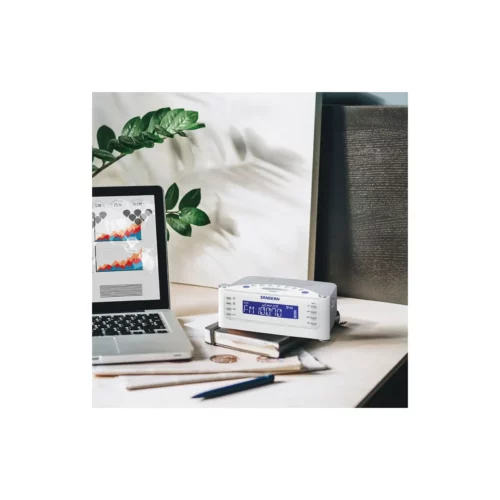 Sangean RCR-22 AM / FM-RBDS / AUX Digital Tuning Radio in white angled left on top of book